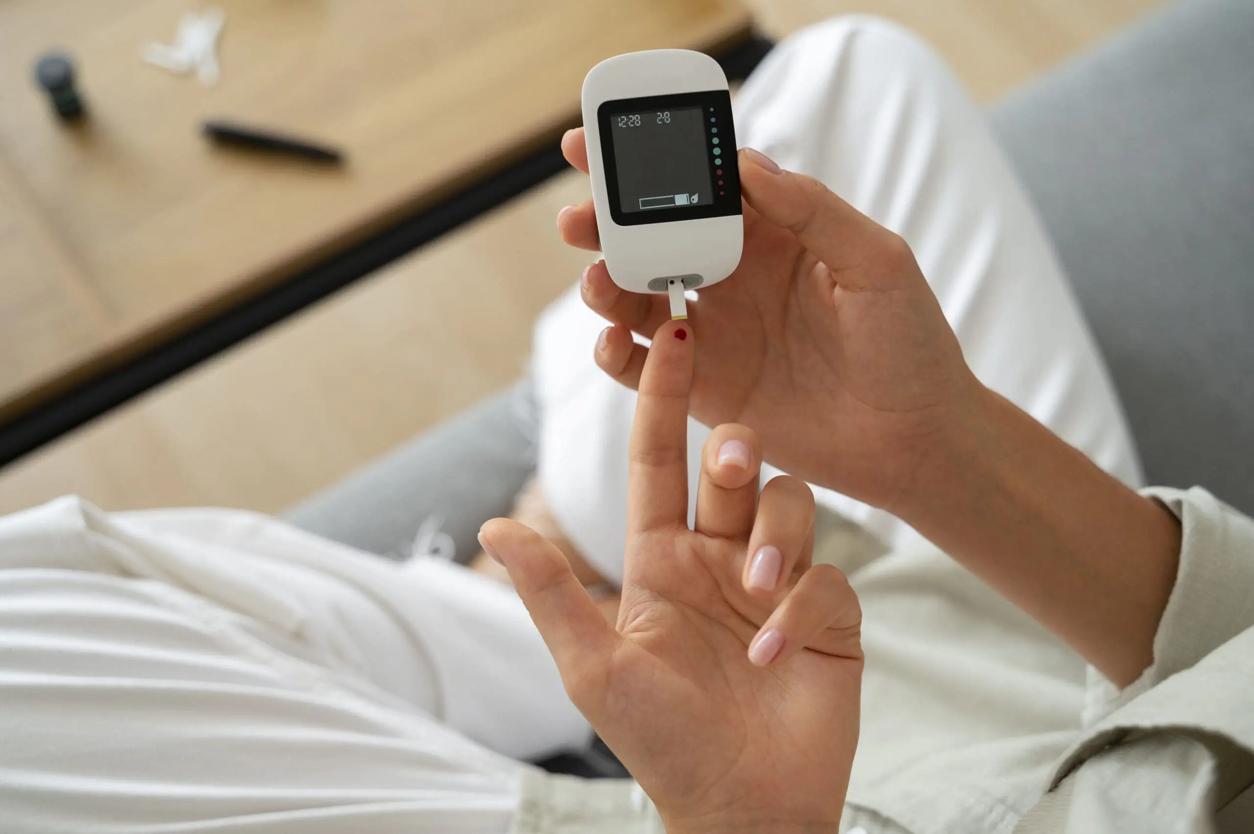 top view diabetic woman checking her glucose level scaled
